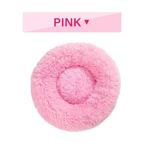 Pink fluffy pet bed with 'PINK' label on a white background