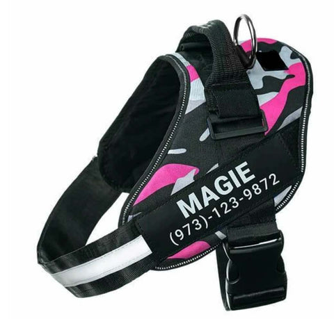 Dog harness with pink and gray camouflage pattern and personalized text on a white background