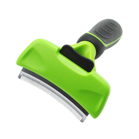 Green and gray pet grooming brush on a white background