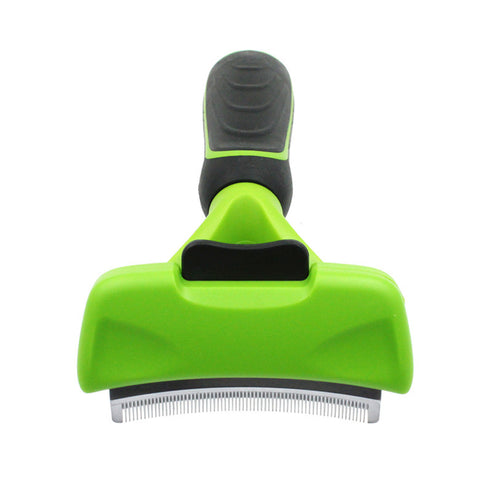 Green pet grooming brush with black handle on a white background