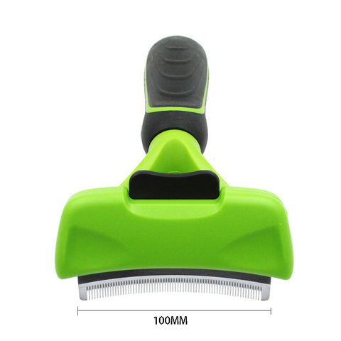 Green pet grooming brush with black handle on a white background