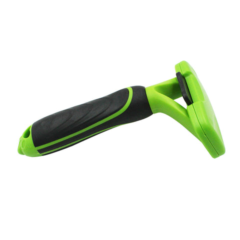 Green and black pet grooming tool on a white background