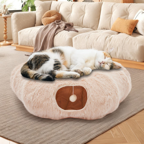 Cat sleeping on a fluffy pet bed in a cozy living room.