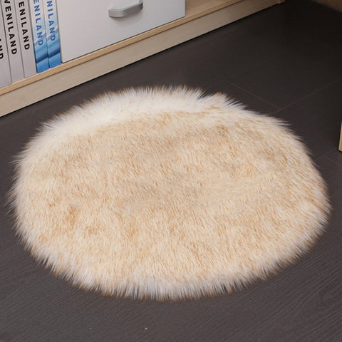 Round beige rug on a dark floor with books in the background