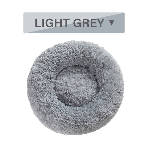 Light grey fluffy pet bed with a label indicating the color on a white background
