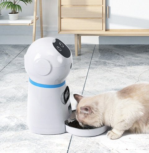 Pet robot feeder dispensing food into a bowl on a tiled floor.